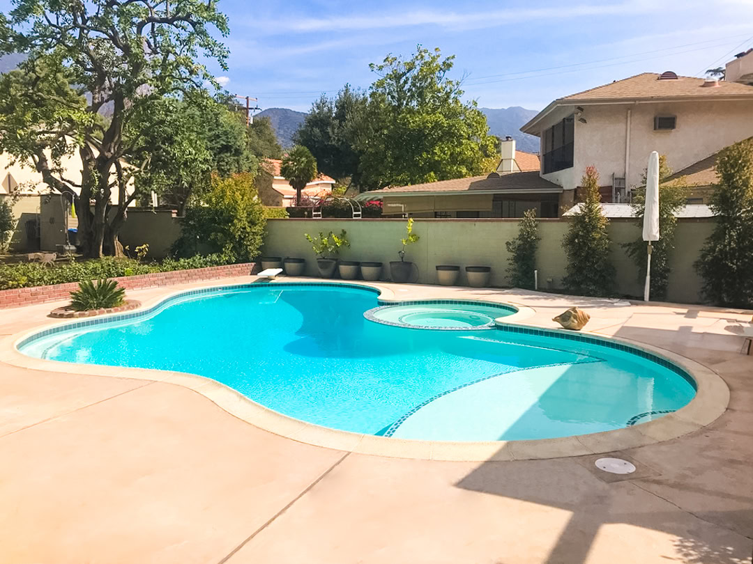A swimming pool remodel by The Pool Pro. Replastered, new tile, added sun shelf (aka tanning shelf, Baja shelf).
