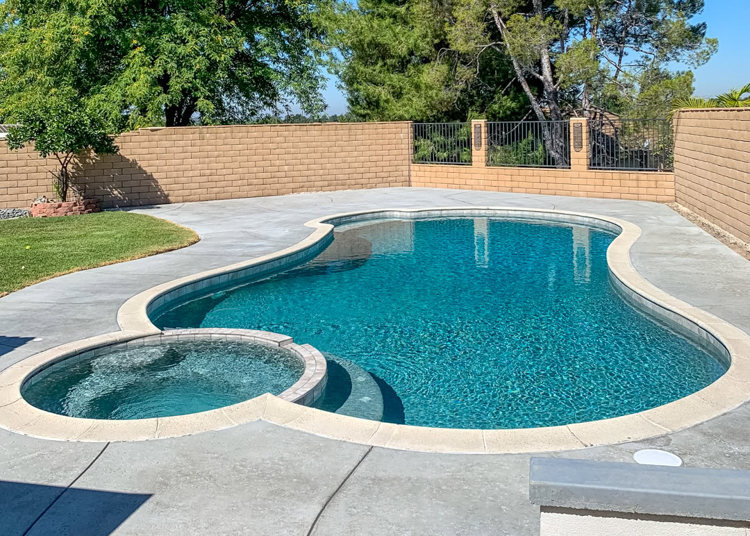A swimming pool remodel by The Pool Pro. Pebble finish, new tile, new deck, new plumbing, new autofill.
